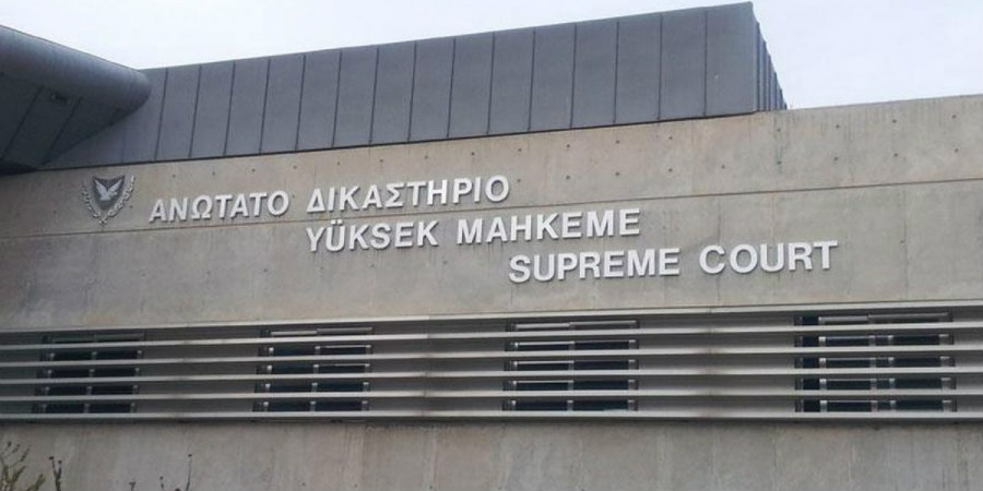 Exterior view of the Supreme Court building in Cyprus with multilingual signage.